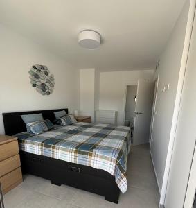 a bedroom with a bed with a plaid blanket at Casa Blu Blu - Your Holidayhome with pool near the Beach! in Santiago de la Ribera +37 photos