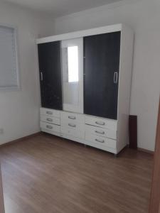 a large entertainment center with a large television in a room at Manacá in Ribeirão Preto