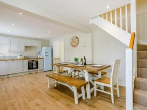 a kitchen and dining room with a table and chairs at City to Country Retreat Luxury Cottage with Hot Tub in Toppesfield