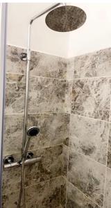 a shower with a shower head in a bathroom at Kirkgate Aprt4 - Duplex Relocations in Wakefield