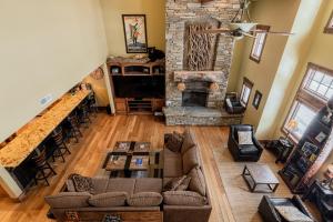 an overhead view of a living room with a stone fireplace at Badgerland Park City - Summer Escape with Year-Round Recreation, Mountain Trail and Private Hot Tub! in Park City