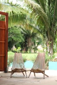 two wooden benches sitting next to each other at Central Oasis Private Pool BBQ in Belmopan