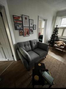 a living room with a couch and a christmas tree at Trendy artisan cottage in Stoneybatter near Dublin City centre in Dublin