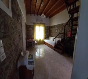 a living room with a bed and a window at Agape’s apartment in Anaxos