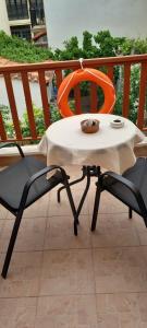 a table and two chairs on a balcony at Agape’s apartment in Anaxos