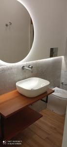 a bathroom with a white sink and a mirror at La dimora degli scrittori in Porto Empedocle