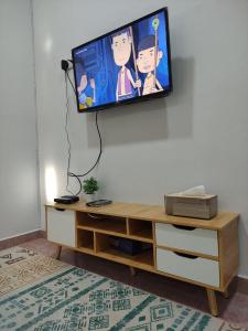a flat screen tv hanging on a wall at Maileyna Homestay 1.0 in Alor Setar