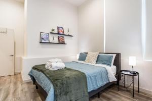 a bedroom with a bed with a blue comforter at Fremont Urban Studio in Seattle