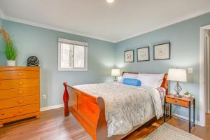 a bedroom with a bed and a dresser with two lamps at Traverse City Retreat with Deck and Lake Access in Traverse City