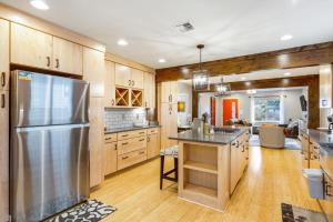 a kitchen with wooden cabinets and a stainless steel refrigerator at Beacon Hill Abode in Seattle