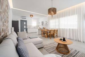 a living room with a white couch and a table at Elaia Retreat Naxos in Vívlos