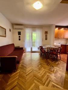 a living room with a couch and a table at Emília apartman in Balatonszemes