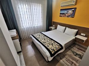 a hotel room with a bed and a window at Maya Apart Antalya in Antalya