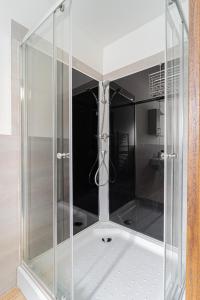 a shower with a glass enclosure in a bathroom at B48 Duplex in Törökbálint