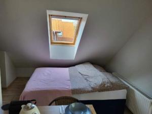 Habitación pequeña con cama y ventana en Apartament w Dębkach en Dębki