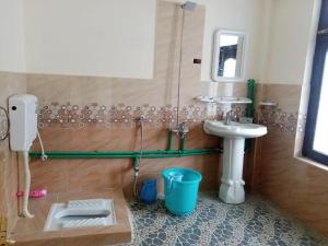 a bathroom with a sink and a toilet and a sink at Yazgar Residency Skardu in Skardu