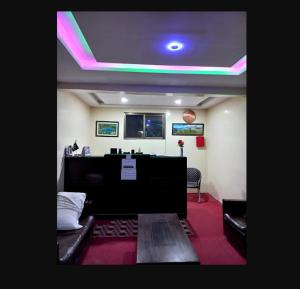 a room with a room with a desk and a green light at Yazgar Residency Skardu in Skardu