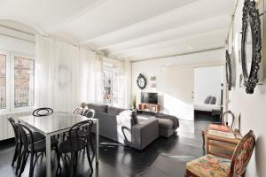 a living room with a table and a couch at Eulalias Lodges Barcelona in Barcelona