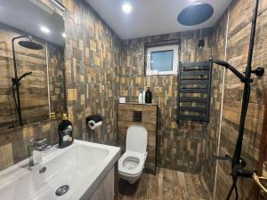 a bathroom with a toilet and a sink at Villa Gusto, 3km from Pamporovo in Pamporovo