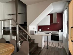 a kitchen with a staircase and a table in a room at Casa Eliseo in Los Yébenes