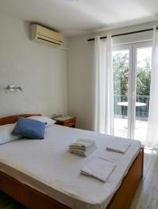 a bedroom with a bed with towels on it at Apartmani Slaviček in Živogošće