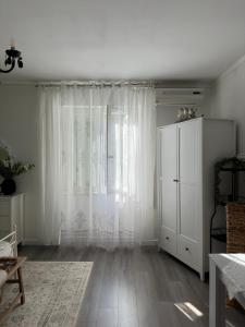 a living room with a white cabinet and a window at Rooms Zana in Split