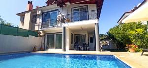 a house with a swimming pool in front of a house at Villa Asel in Dalyan