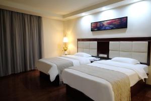 Giường trong phòng chung tại Huahang Hotel (Guangzhou New Baiyun International Airport)