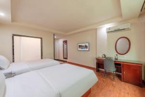 Giường trong phòng chung tại Huahang Hotel (Guangzhou New Baiyun International Airport)