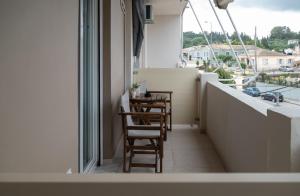 a balcony with chairs and a view of a city at solarisuites in Mantoúkion