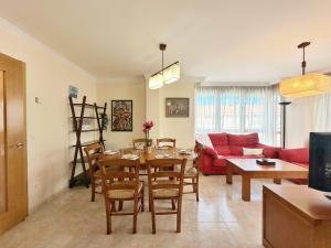 a living room with a table and a red couch at El Patuco - 6821 in Noja