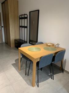 una mesa de madera con sillas alrededor en una habitación en Apartament w Dolinie Sanu 1 en Lesko