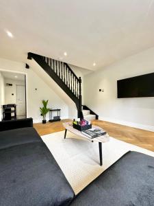 a living room with a couch and a tv at Canal Mews in Manchester