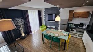 kuchnia i salon ze stołem i krzesłami w obiekcie Lux Apartment Modern w Polanicy Zdroju
