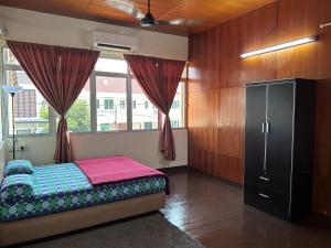 a bedroom with a bed and a window at Minden Stay in Gelugor