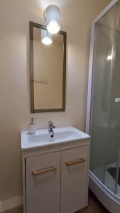 a bathroom with a sink and a mirror and a shower at Pink House Dziwnów 250 m od Morza in Dziwnów +38 photos