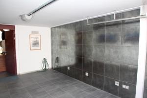 a room with a black wall and a tile floor at Casa Molinar in Palma de Mallorca