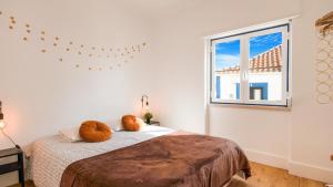 a bedroom with a bed with two pillows on it at Ericeira 2BDR Coastal Escape by LovelyStay in Ericeira