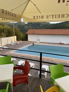 a view of a swimming pool from a table and chairs at Etno Domacinstvo Mitrovic 