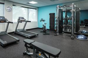 a gym with cardio equipment in a room with blue walls at Avid Hotels - Roseville - Minneapolis North, an IHG Hotel in Roseville