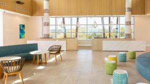 a lobby with tables and chairs and windows at Holiday Inn Club Vacations Myrtle Beach Oceanfront in Myrtle Beach