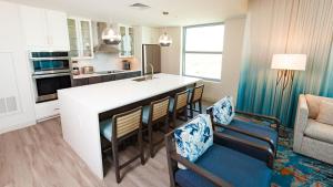 a kitchen and living room with a large white island at Holiday Inn Club Vacations Myrtle Beach Oceanfront in Myrtle Beach
