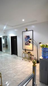 a room with a table and a picture on the wall at SHORTLETMART Apartments in Lekki