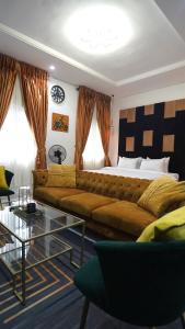 a living room with a couch and a bed at SHORTLETMART Apartments in Lekki