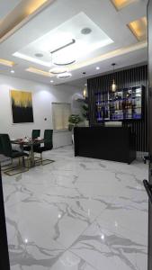a lobby with a marble floor and a table and chairs at SHORTLETMART Apartments in Lekki