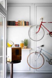 a bike hanging on a wall next to a microwave at Das Quartier in Klagenfurt