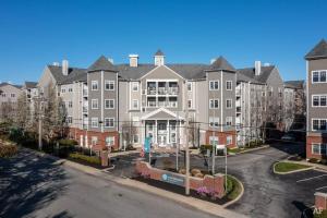 a large apartment building with a street in front of it at Comfortable Apartment with Pool Gym & other Amenities #2306 in Woburn