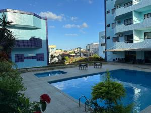a swimming pool in front of a building at Norte Palace Hotel in São Mateus