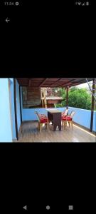 two pictures of a table and chairs on a deck at Sunrise View Homestay in Tānsing