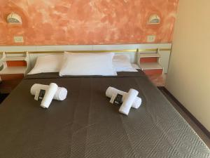 Postel nebo postele na pokoji v ubytování Hotel Majestic